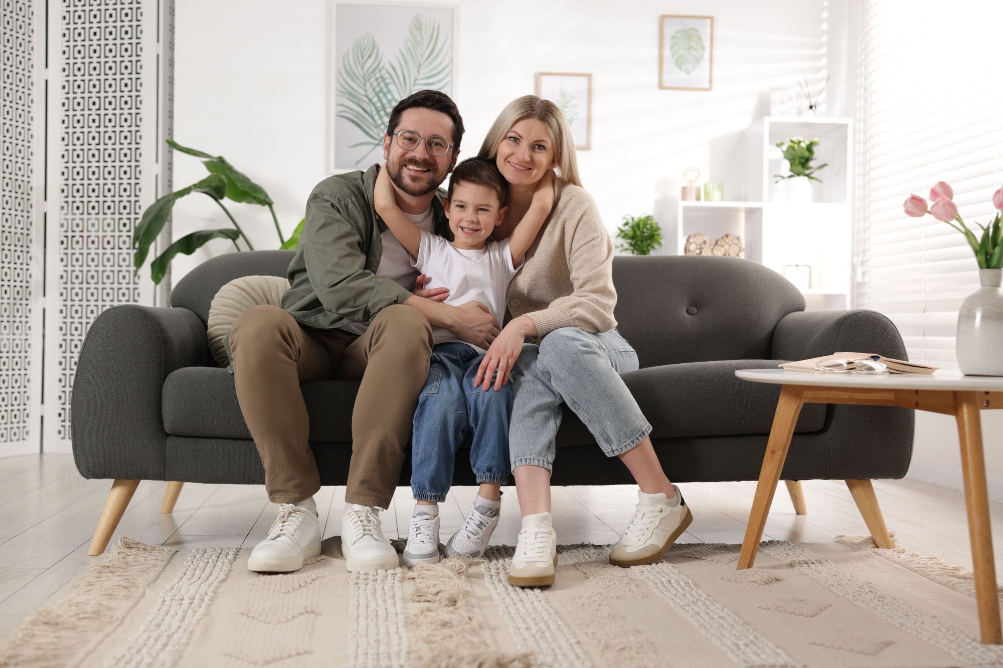 Portrait of happy family on sofa at home